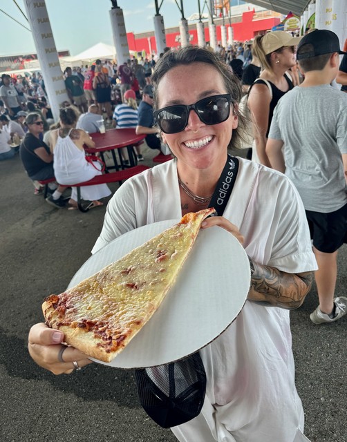 Dodgin the heat under the grandstands, eating a giant terrible slice of pizza from Bacci